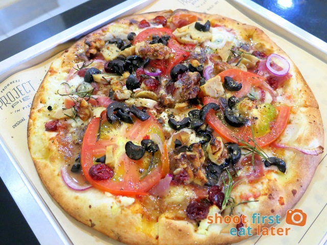 #5 pizza with gorgonzola, ricotta, mozzarella, anchovies, prosciutto, caramelized onions, tomato, mushroom, walnuts, olives, dried cranberries